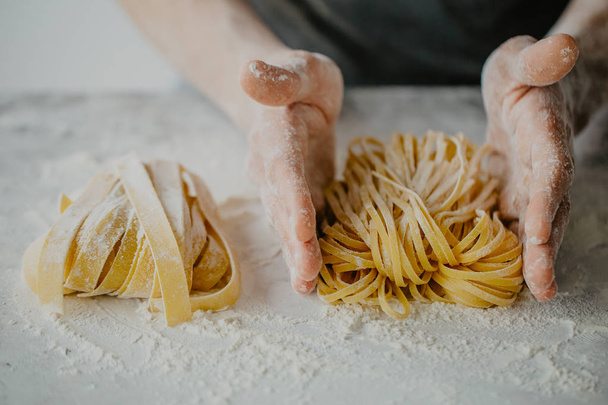 Closeup of process of making cooking homemade pasta. Chef make fresh italian traditional pasta  - Fotografie, Obrázek