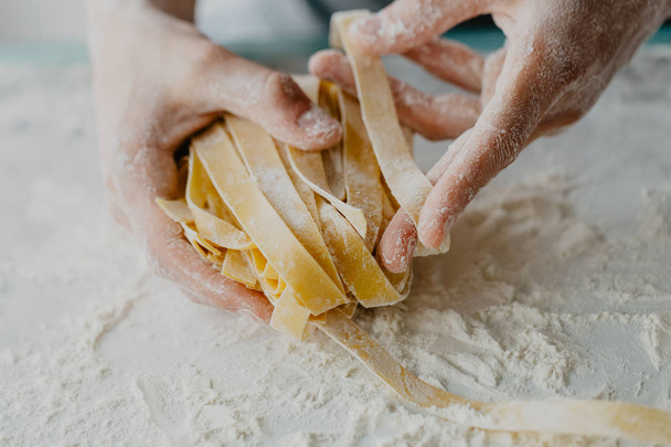 Closeup of process of making cooking homemade pasta. Chef make fresh italian traditional pasta  - Φωτογραφία, εικόνα