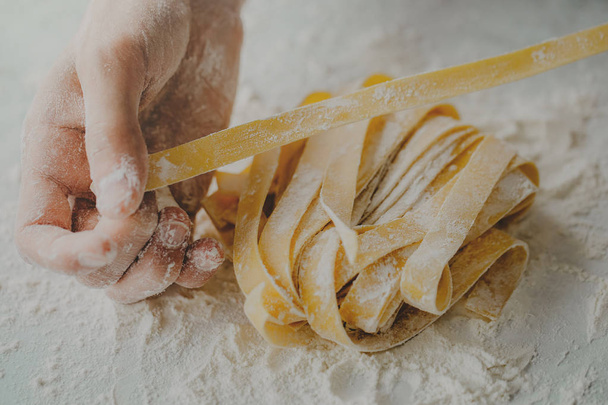 Closeup of process of making cooking homemade pasta. Chef make fresh italian traditional pasta  - Фото, зображення