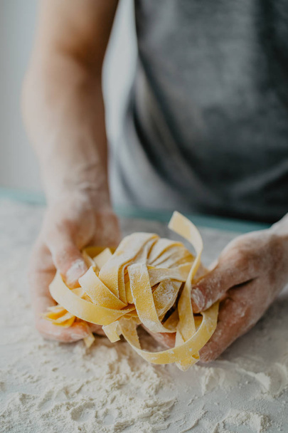 Closeup of process of making cooking homemade pasta. Chef make fresh italian traditional pasta  - Фото, зображення