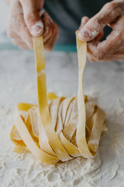 Closeup of process of making cooking homemade pasta. Chef make fresh italian traditional pasta  - Foto, imagen
