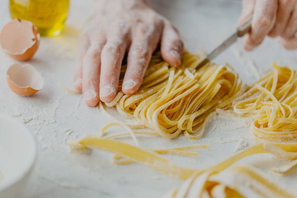 Closeup of process of making cooking homemade pasta. Chef make fresh italian traditional pasta  - Valokuva, kuva