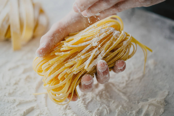 Closeup of process of making cooking homemade pasta. Chef make fresh italian traditional pasta  - Foto, imagen