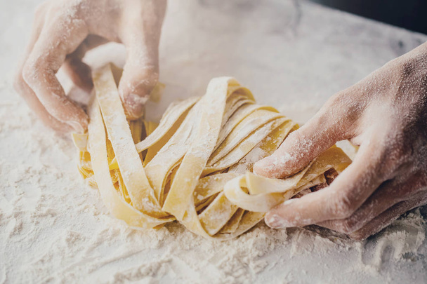 Close-up van het proces van het maken van zelfgemaakte pasta koken. Chef-kok maken van verse Italiaanse traditionele pasta  - Foto, afbeelding