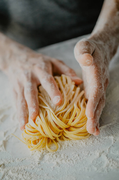 Closeup of process of making cooking homemade pasta. Chef make fresh italian traditional pasta  - Zdjęcie, obraz