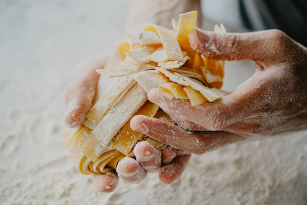 Closeup of process of making cooking homemade pasta. Chef make fresh italian traditional pasta  - Photo, image