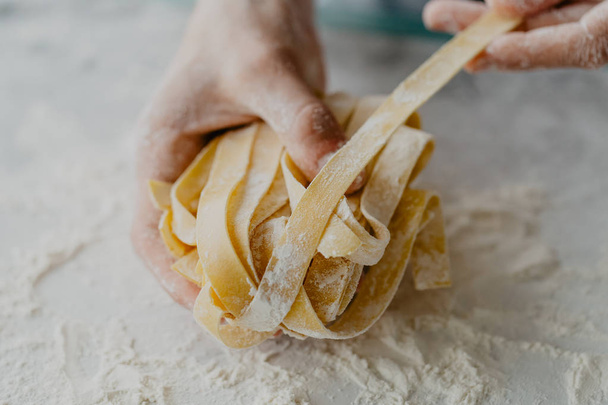 Closeup of process of making cooking homemade pasta. Chef make fresh italian traditional pasta  - Foto, Imagen