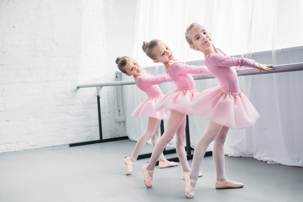 graceful elegant little ballerinas practicing together in ballet studio - Photo, Image