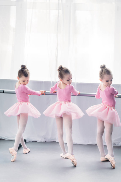 back view of graceful little ballerinas practicing ballet in studio - Photo, Image