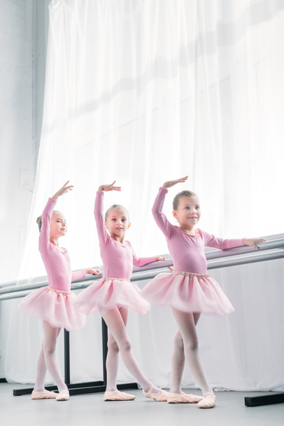 low angle view of beautiful little ballerinas dancing in ballet studio - Valokuva, kuva