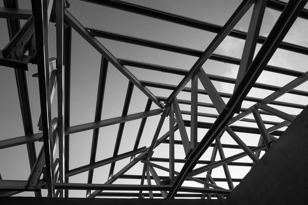 Structure of steel roof frame for building construction. Black and white photo. - Photo, Image