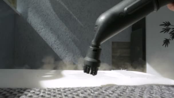 Home sofa cleaning concept with a water vapor steam cleaner closeup - Footage, Video