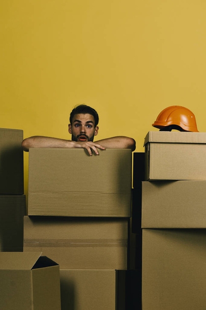 Delivery and moving concept. Guy with bristle leans on boxes - Foto, immagini