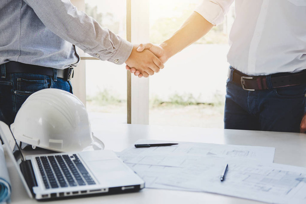 Two engineer or architect meeting for project, handshake after consultation and conference new project plan, contract for both companies, success, partnership. - Foto, Imagem