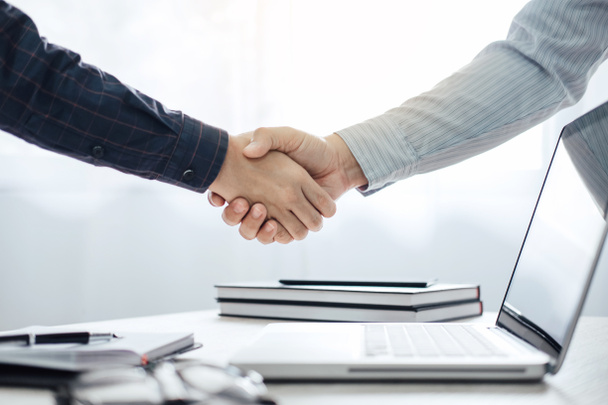 Business partnership meeting concept, Two confident Business handshake and business people after discussing good deal of Trading contract and new projects for both companies, success, partnership. - 写真・画像