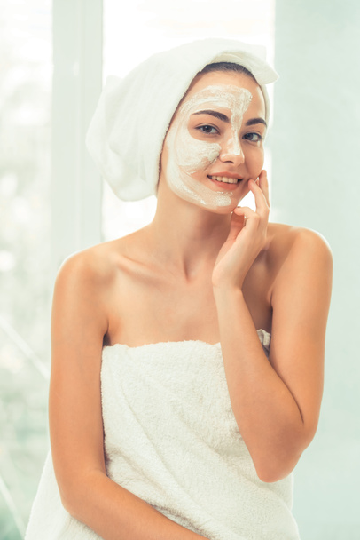 Beautiful woman having a facial cosmetic scrub treatment from professional dermatologist at wellness spa. Anti-aging, facial skin care and luxury lifestyle concept. - Foto, Imagen
