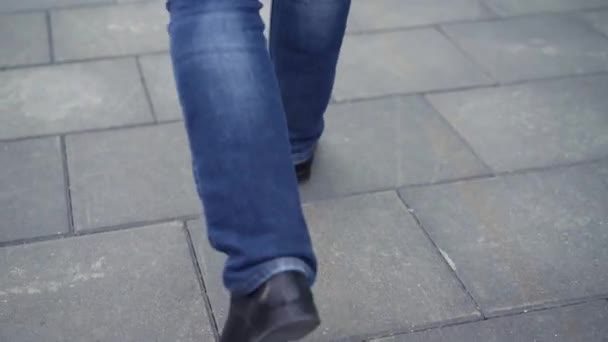 Close up of mans black leather shoes he walking in the city. Stock. Close-up of businessmans legs - Footage, Video