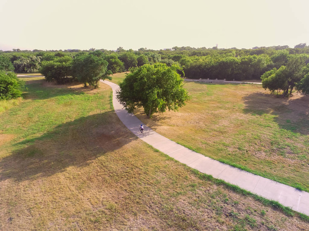 Top vista parque pavimentado caminho com motociclista andar de bicicleta em Irving, Texas, EUA. Caminho de visão aérea para andar, correr, andar de bicicleta, patins
 - Foto, Imagem