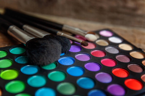 Close-up de pincéis de maquiagem na paleta de sombra
 - Foto, Imagem