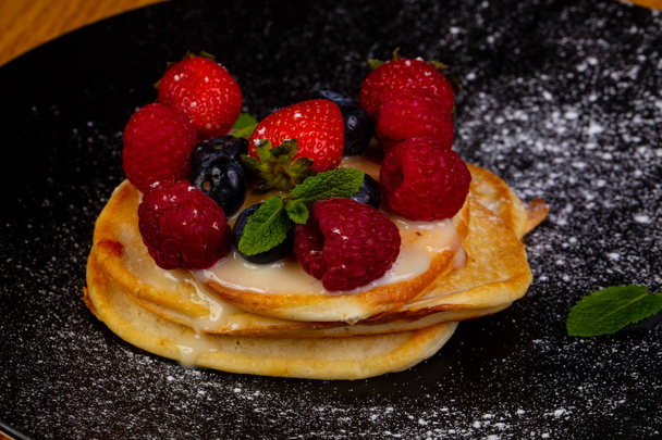 Pancakes with berries served mint leaves - Photo, Image