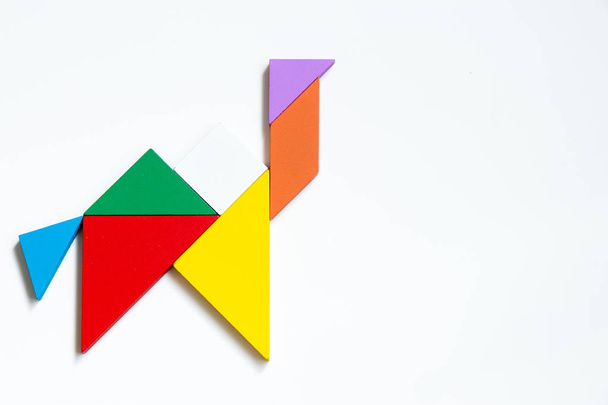 Quebra-cabeça tangram de madeira colorida em forma de camelo no fundo branco
 - Foto, Imagem