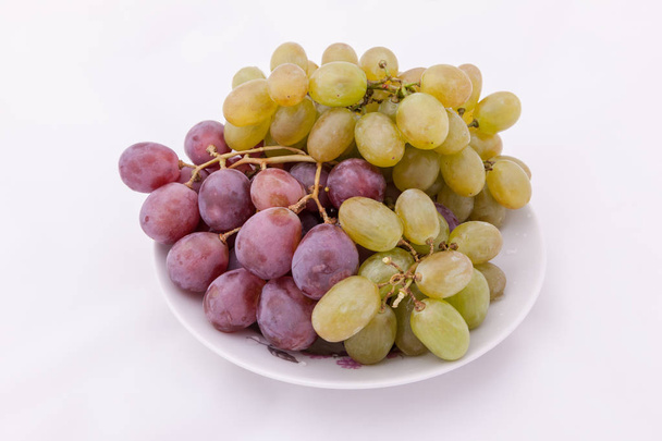 grappes de raisins violets et verts sur une assiette
 - Photo, image
