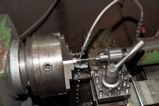 The cooled water to parts on a lathe. Metalworking industry - Photo, Image