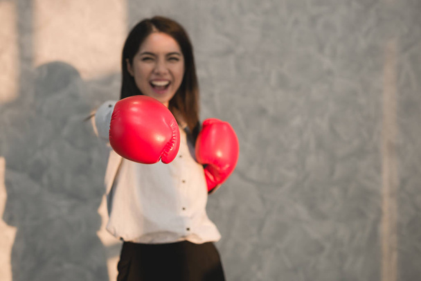 Girls Asian businessman wearing boxing gloves red hand displaying the symptoms I'm delighted winner. Business Success  concept - Fotoğraf, Görsel