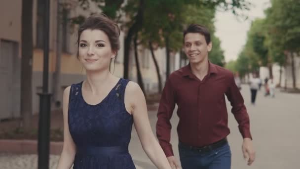 Handsome man try catch up beautiful girlfriend. Young man and woman having fun - Video, Çekim