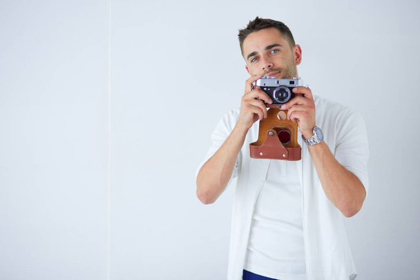 Young man with camera. Isolated over white background - Foto, Imagem