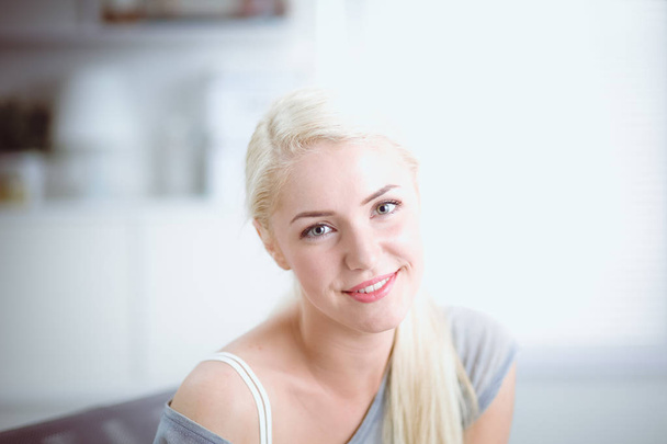 Young beautiful woman sitting on couch at her room - Fotoğraf, Görsel