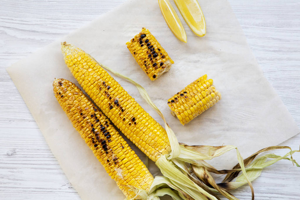 Top view, grilled corn on the cob with salt and slices of lemon. Summer food. Closeup. From above, flat lay, overhead. - Photo, Image