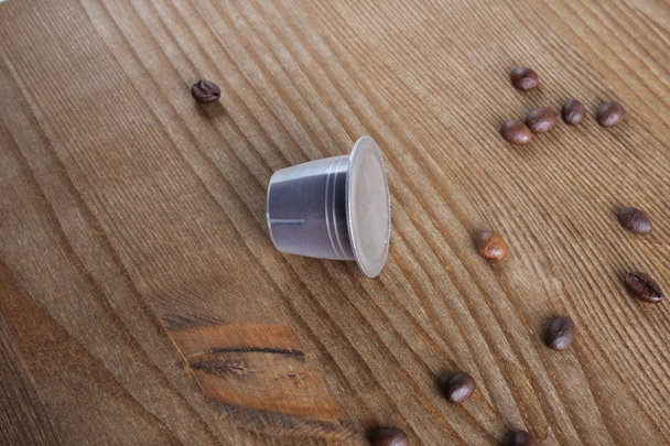 capsules of coffee on a wooden background - Valokuva, kuva