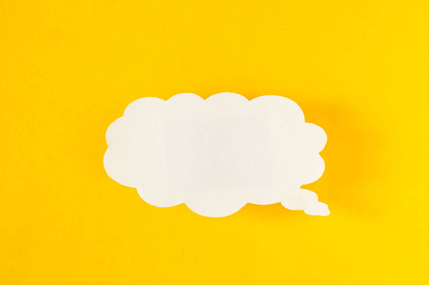 Message in the form of a cloud of paper on a yellow background, social networks, eddy, symbol - Photo, Image