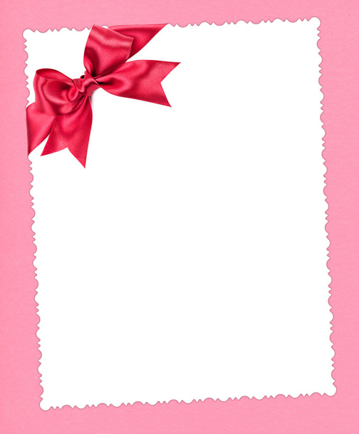 blank paper sheet with red bow on pink - Photo, Image