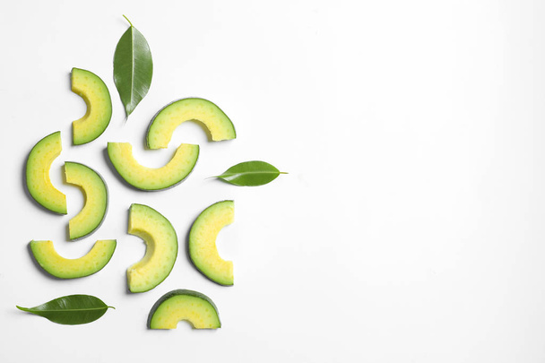 Composition with sliced ripe avocado on white background - Foto, Imagem