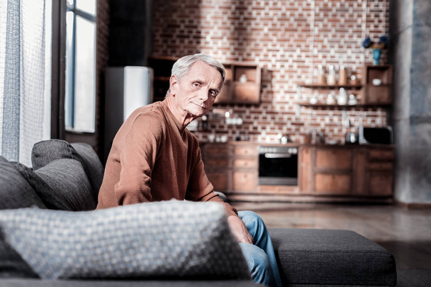 Thoughtful pensioner sitting at home - Foto, Imagen