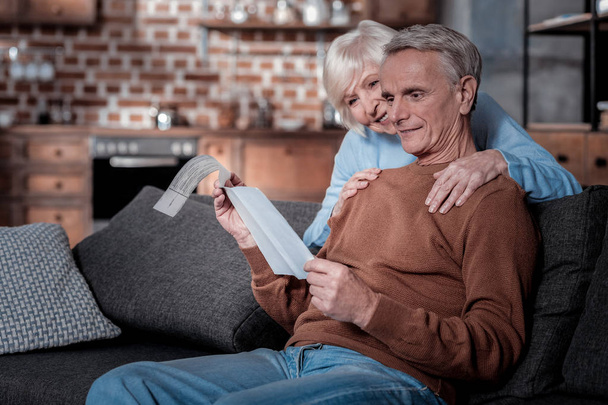 Pleased elderly people checking their pension - Foto, Imagem
