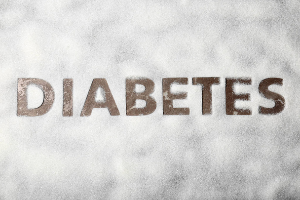 Silhouette of word DIABETES on scattered sugar, top view - Photo, image
