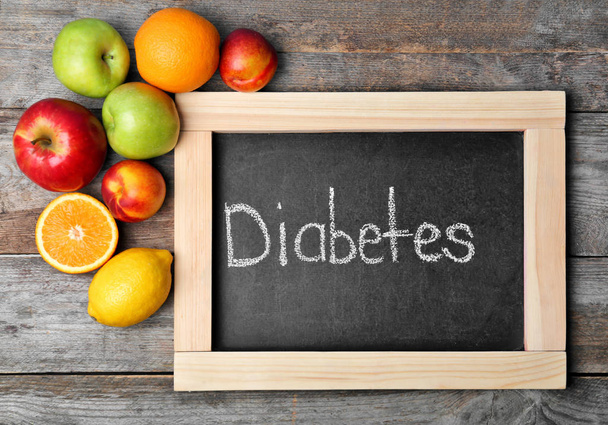 Flat lay composition with word DIABETES and fruits on wooden background - Foto, Imagem