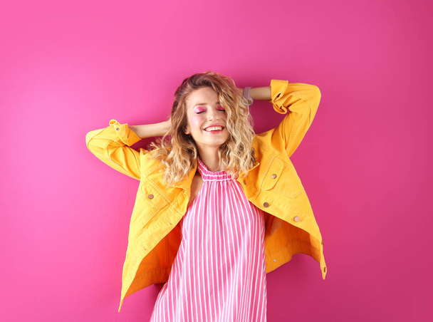 Beautiful young woman posing on color background. Summer fashion - Фото, зображення