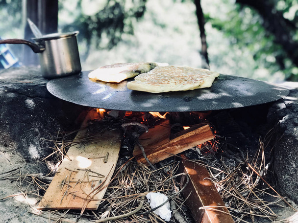 Turkish Food Gozleme Cooked in Wood Fire Pan in the Forest. Organic Food. - 写真・画像