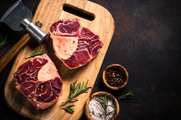 Raw beef steak osso bucco on cutting board. - Photo, Image