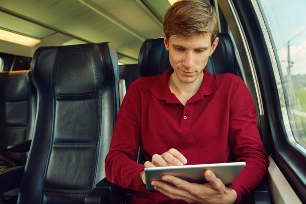 man using tablet computer on the train - Φωτογραφία, εικόνα