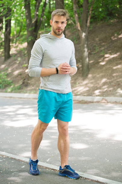 sportsman. sportsman training in park. muscular sportsman relax after training. fashion sportsman on road in forest. getting ready for running. - 写真・画像