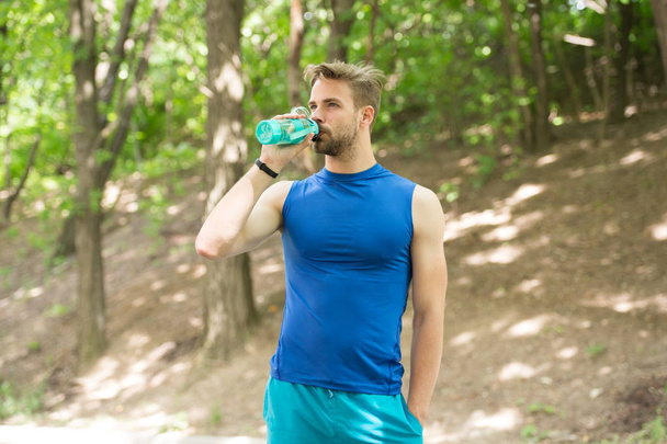 drinking water. man drinking water after training. man drinking healthy water. sportsman has thirst and drinking water. refreshing and useful. - Foto, Imagem