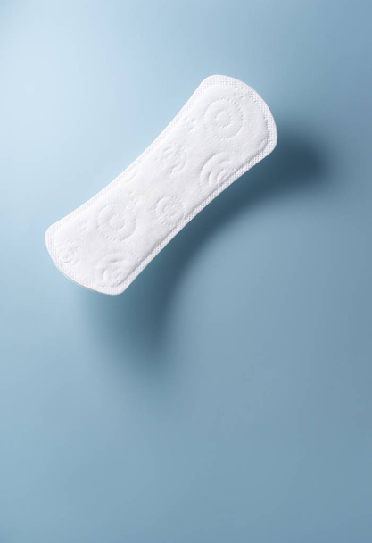 close up view of woman's sanitary pad on color back - Φωτογραφία, εικόνα