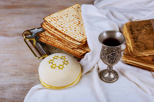 Passover background red wine and matzoh jewish holiday pesah bread over wooden board . - Photo, Image