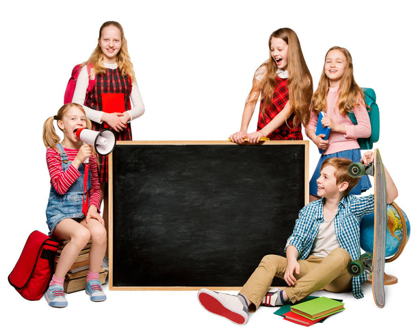 Children Group with Advertisement on Blank School Blackboard, Students Isolated over White Background - Foto, Imagen