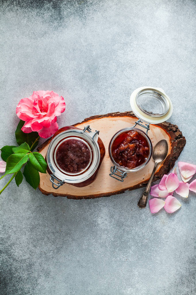 freshly made homemade jam from roses. summer conservation. on grey stone table - Fotoğraf, Görsel